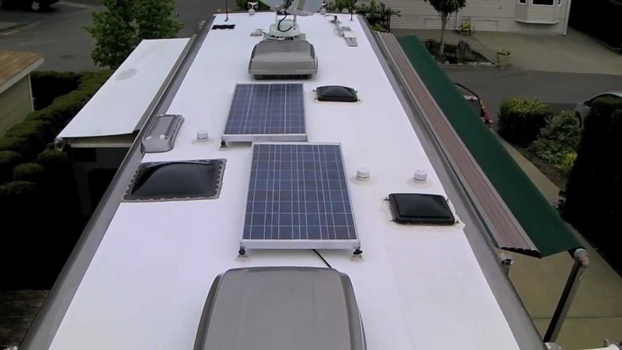 RV roof with HVAC units, fans, skylight, and solar panels