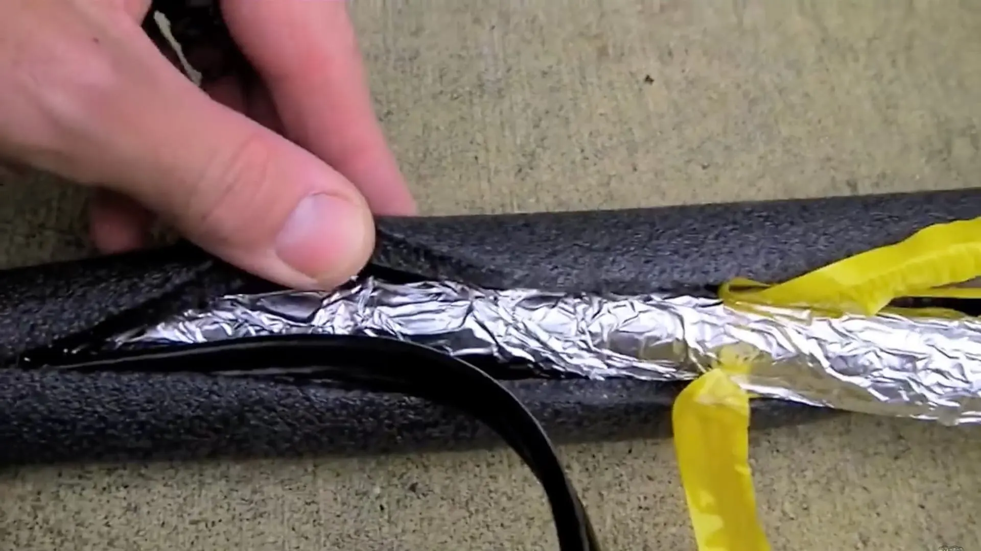 aluminum foil covers hose before using heat tape for RV water hose