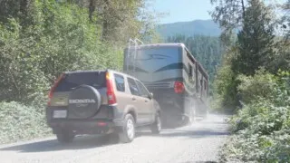 Photo of our motorhome towing our SUV uphill