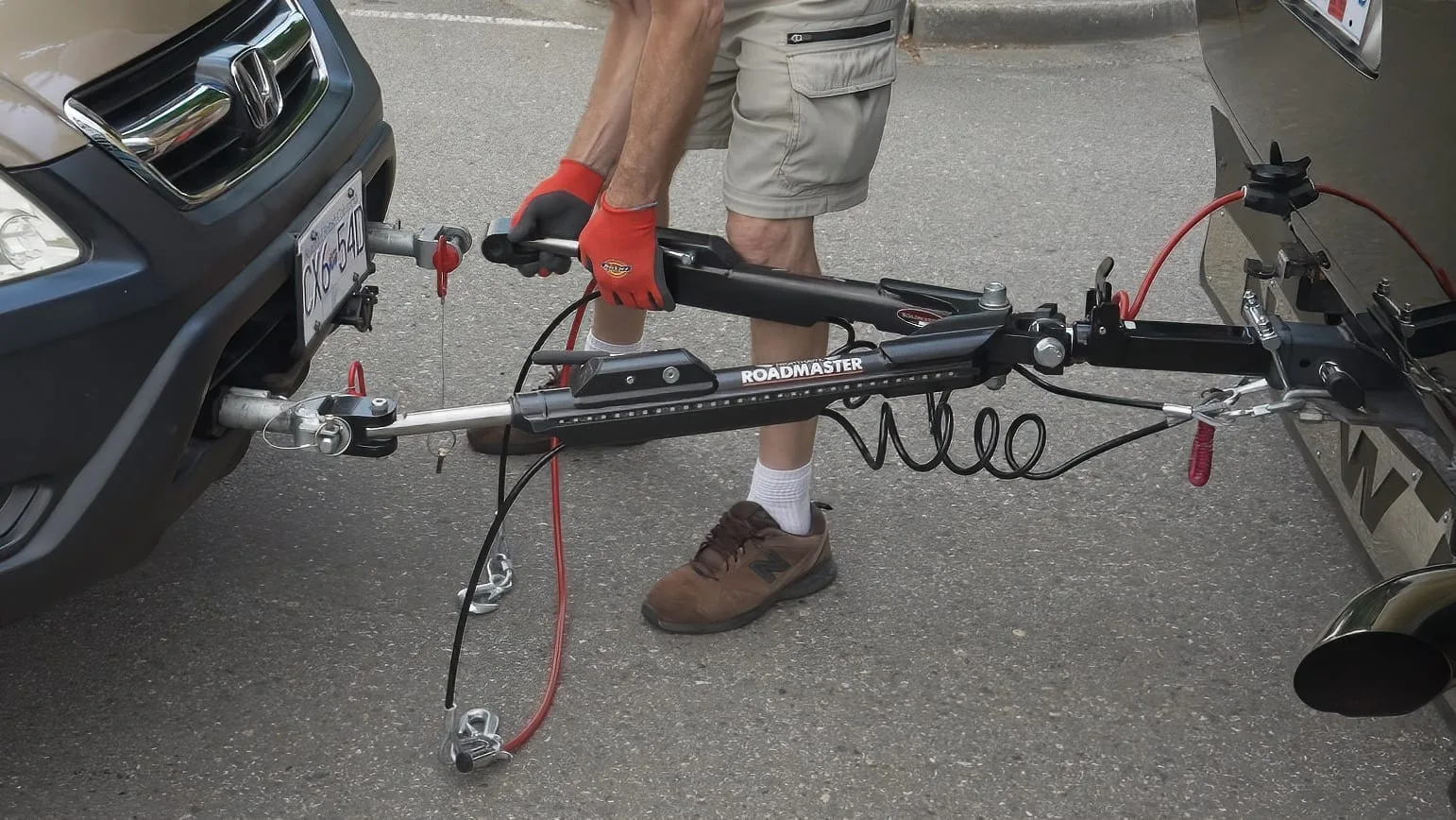 Tow bars have arms that attach to connections on the vehicles they tow.