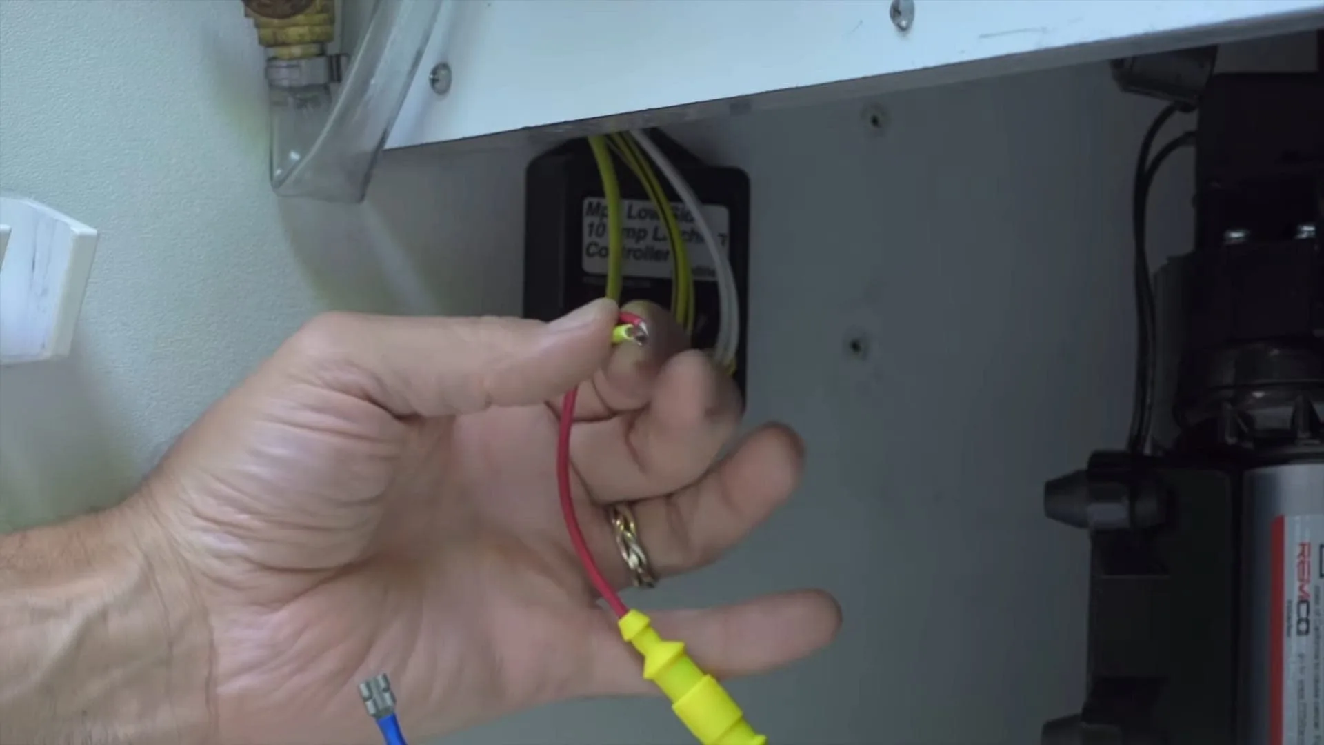 The red and yellow wires of the latching controller are crimped together.