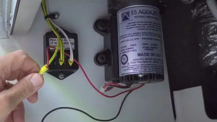 During an RV water pump replacement you'll disconnect the positive lead and snip the yellow wire.