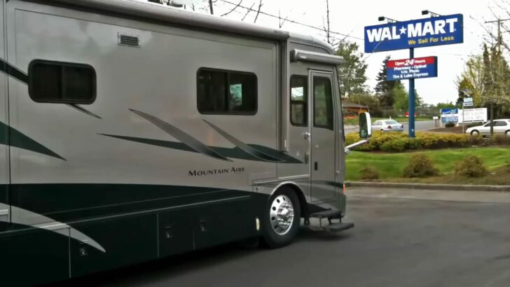 Our RV parked for the night in a Walmart parking lot, with the Walmart sign showing above us.