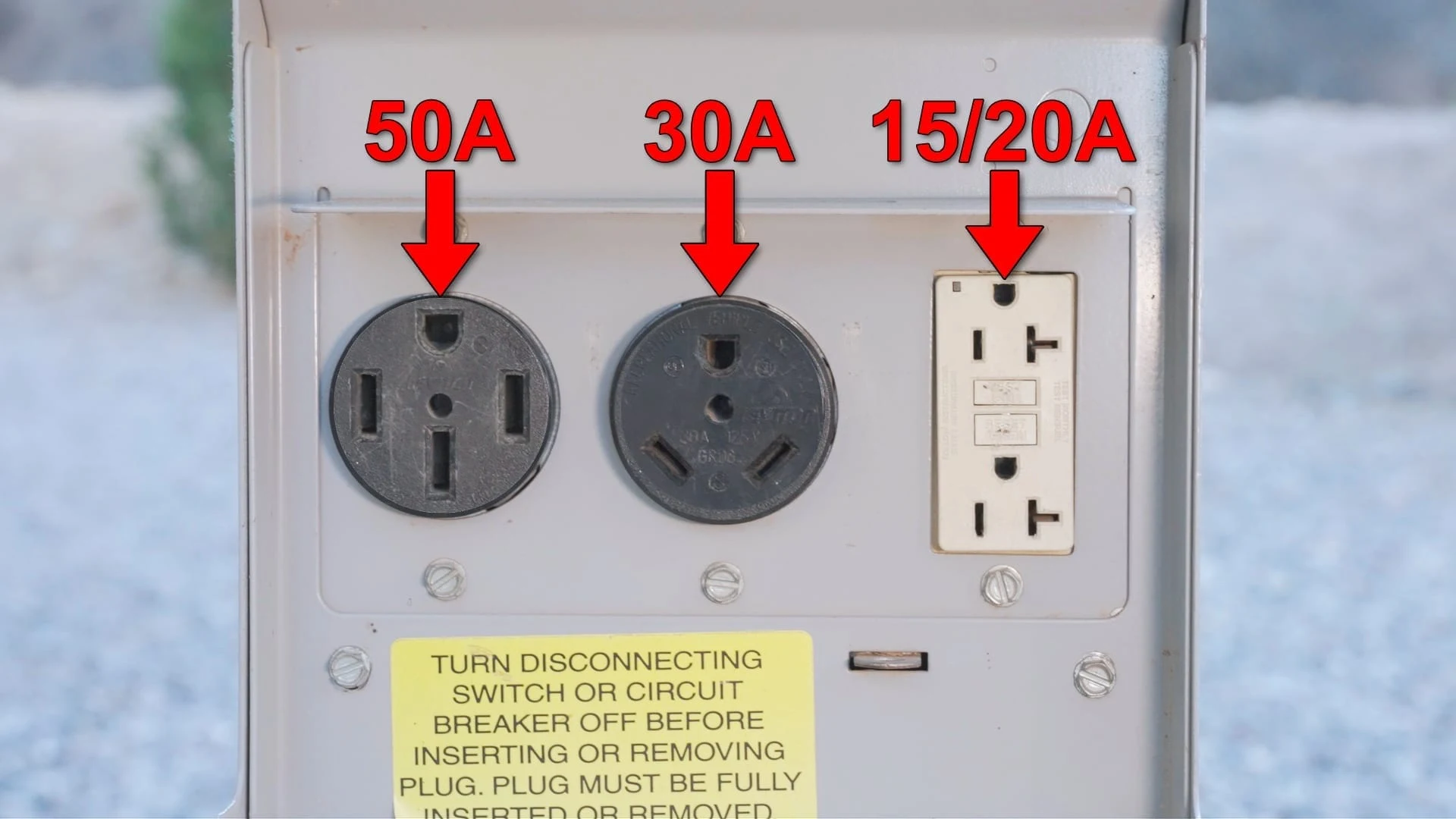 RV microwave not working? Photo of a campsite power pedestal with outlets identifiedwith all three sizes of plugs
