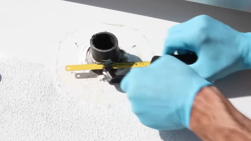 using hacksaw to cut the vent pipe