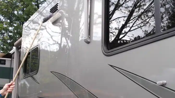 Using a silicone squeegee to pull water off the side of the RV to avoid water spots.