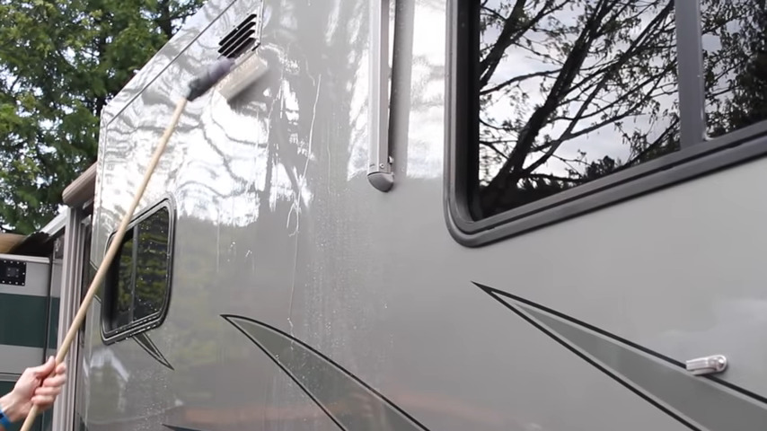 Using a silicone squeegee to pull water off the side of the RV to avoid water spots.