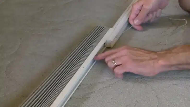 laying the cord inside the track as we restring RV pleated shade