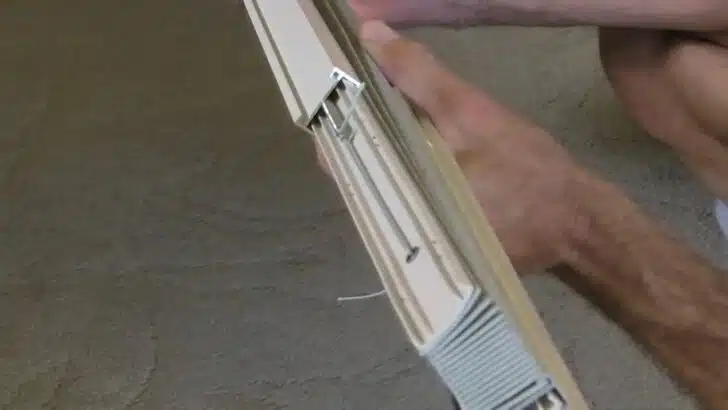 sliding upper track into place while restringing our RV pleated shade