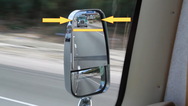 arrows showing the top 1/4 to 1/3 of the mirror with vehicle in the distance