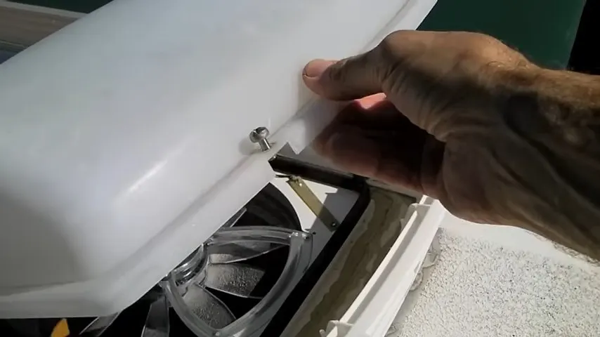 opening the cover that sits over our rv roof vent fan