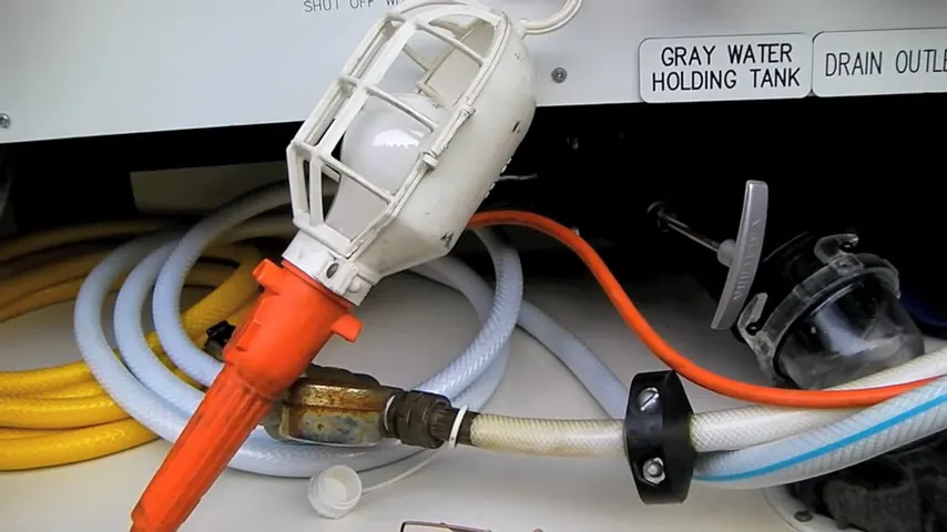 A 60W incandescent light prevents pipes from freezing during winter RV camping trips.