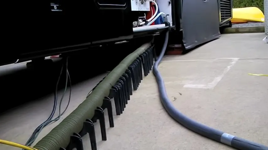 Sewer hose on a downhill slant for winter RV camping.