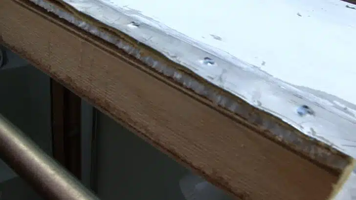 Checking for damage during the RV roof vent fan replacement process.