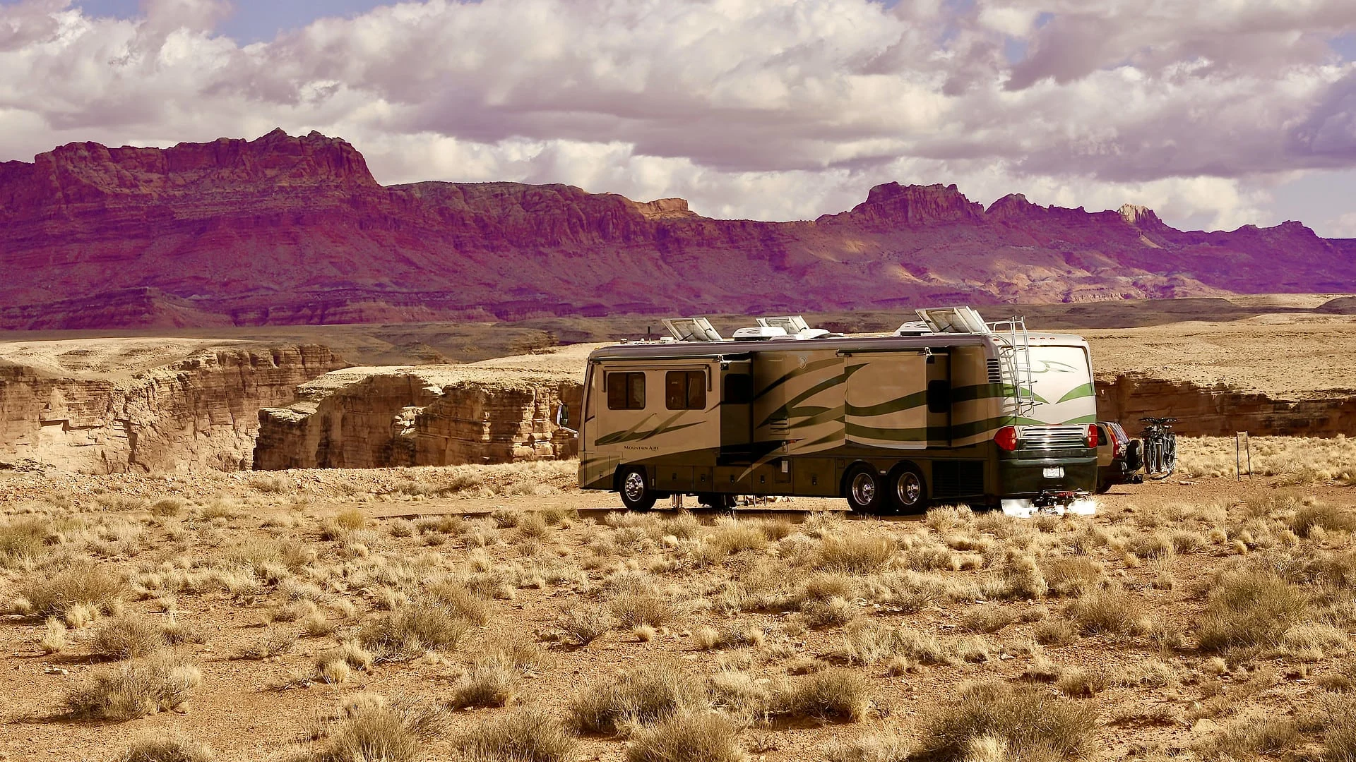 Our RV parked in a desert landscape while dry camping in Arizona.