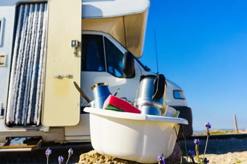 RV outdoor showers provide a great way to wash dishes outside, saving space in the gray tank.