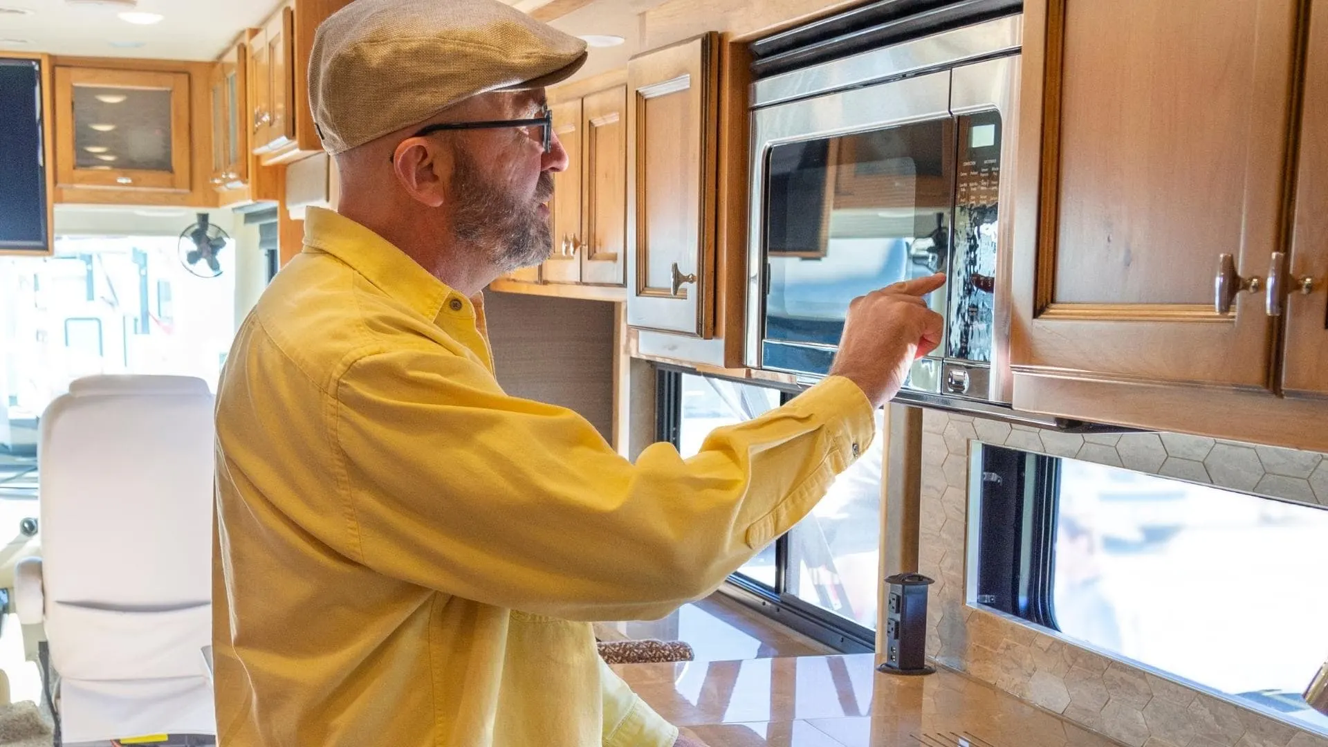 A man checking an RV microwave