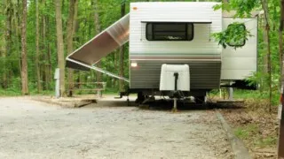 Travel trailer on jack stands at campground