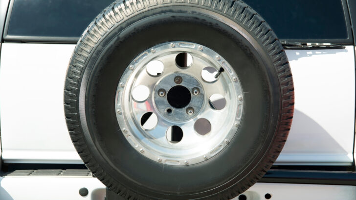 A spare tire mounted on the back of a vehicle