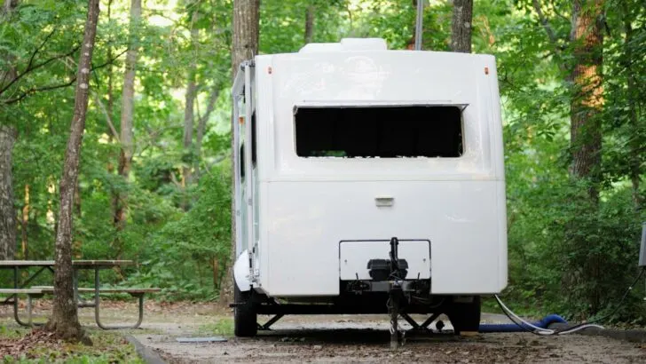 Travel trailer on jacks at campsite