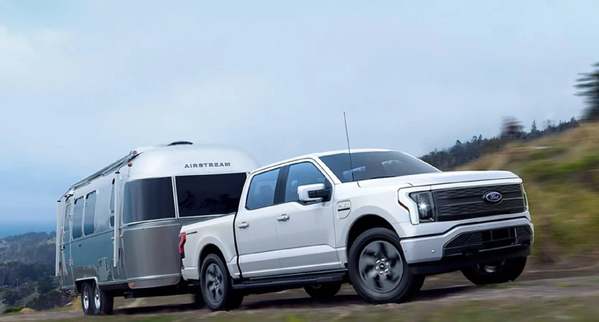 Photo of the Ford F-150 Lightning all-electric pickup truck towing an Airstream.