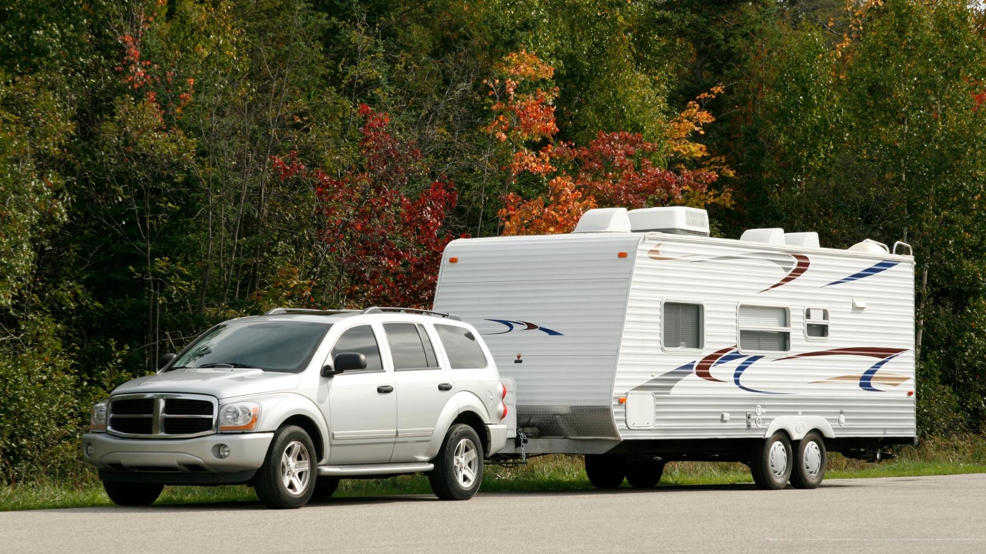 Photo of an SUV towing a travel trailer.
