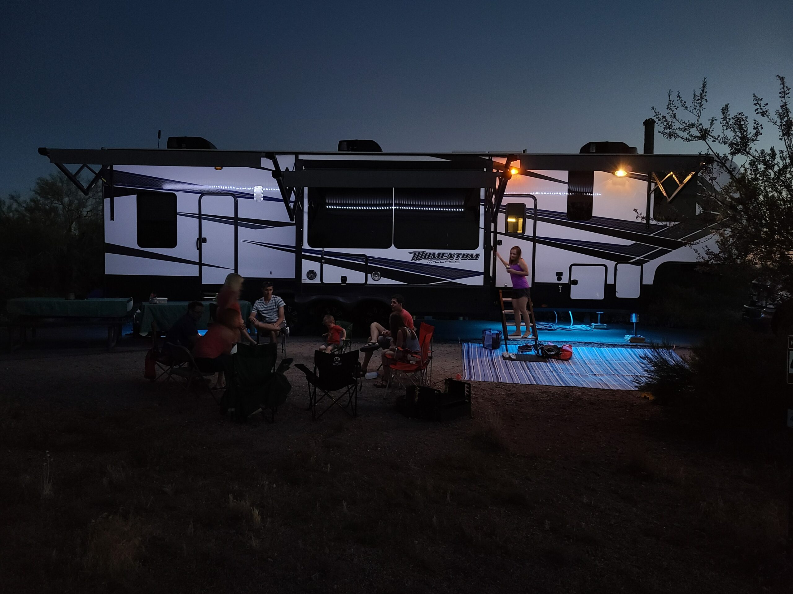 Photo of a toy hauler at a campsite at night
