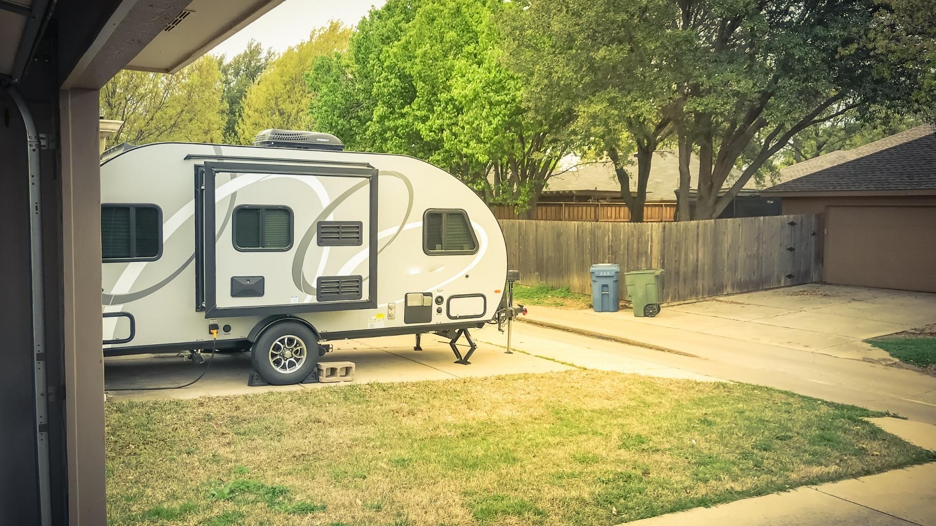 Photo of a travel trailer parked in a driveway