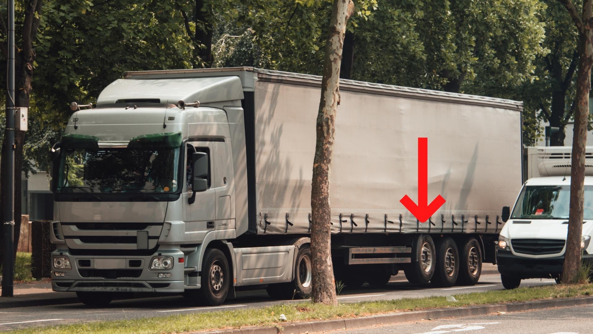 Photo of a freight truck with a lifted tag axle