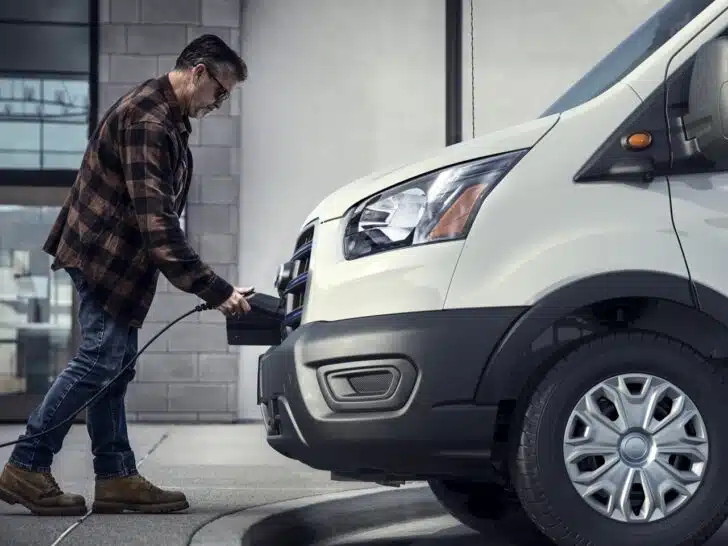 Photo of a man charging a Ford Transit Electric van