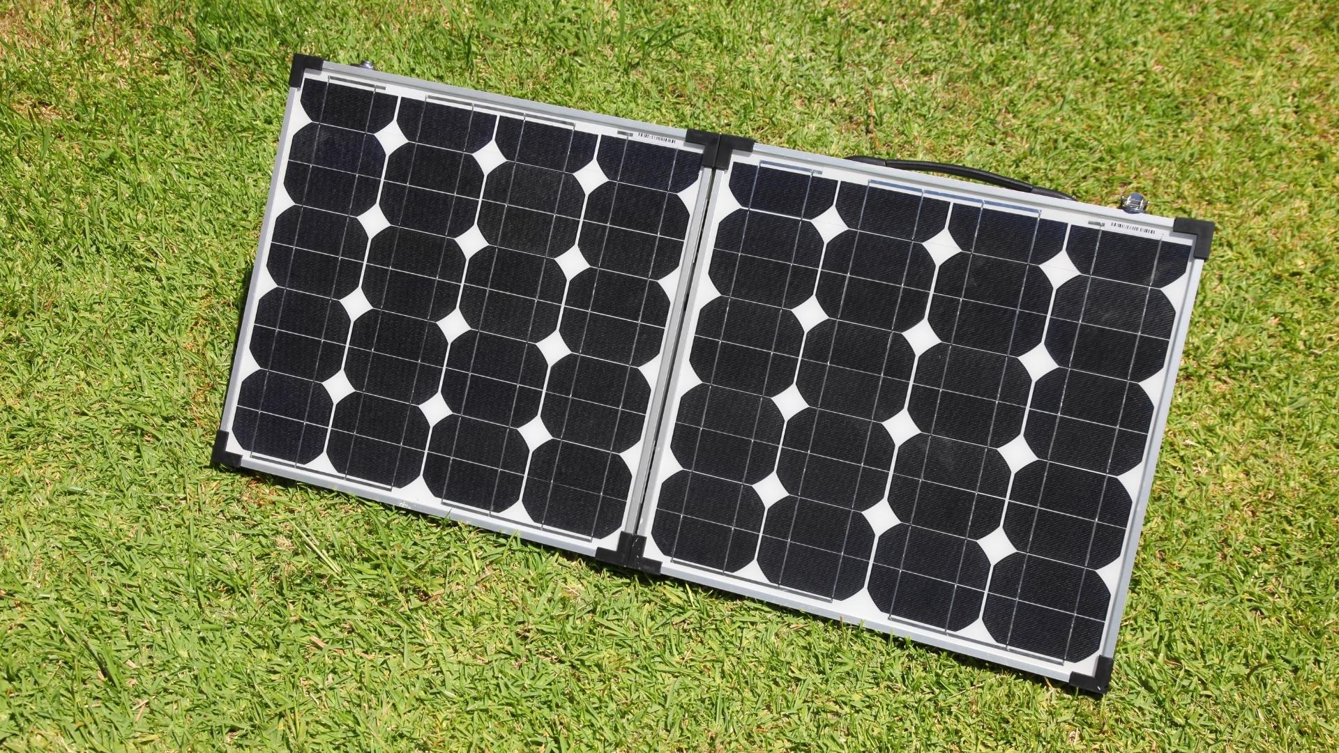 Photo of portable solar panels on the grass, angled toward the sun