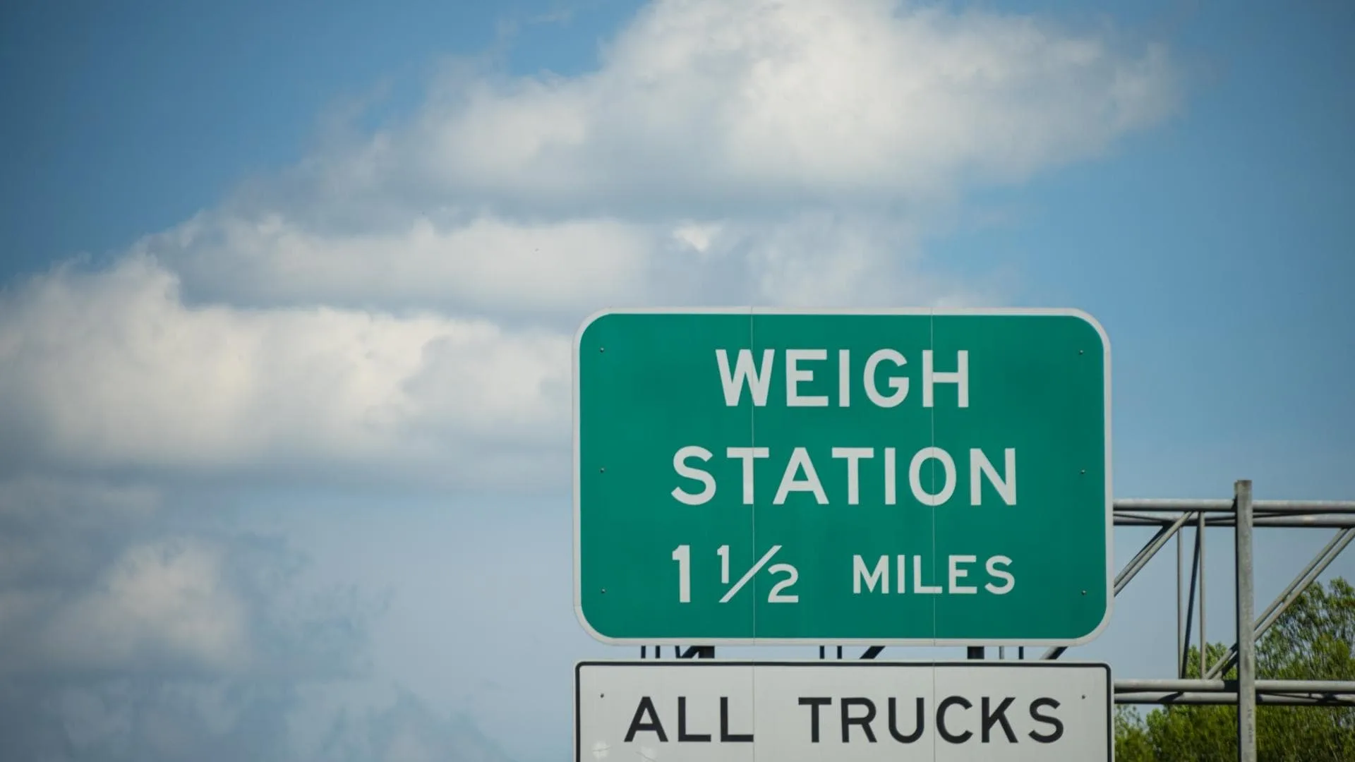 Photo of a highway sign for a weigh station for trucks