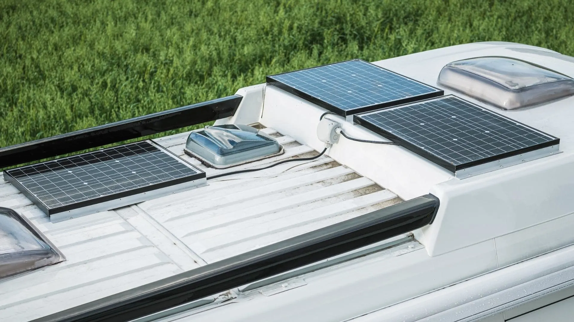 Photo of three solar panels wired in series on the roof of an RV