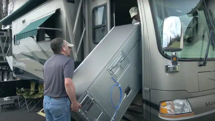 Correct RV tire pressure may change, as in this photo of the RVgeeks moving a new refrigerator through the door of our motorhome