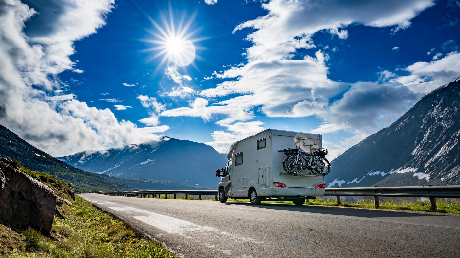 Photo of an RV driving in the mountains