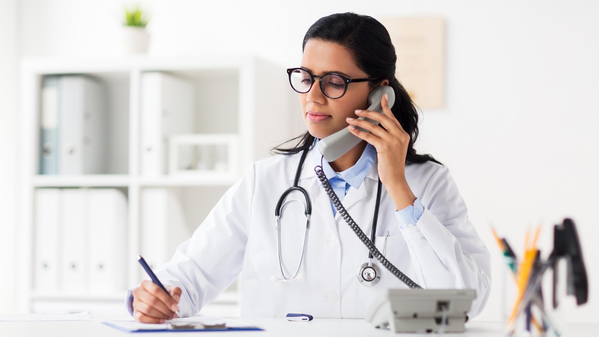 Photo of a physician on the phone with a telehealth patient