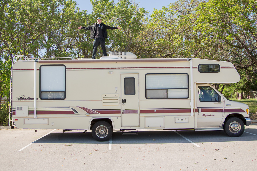 Photo of Heath on the roof of Franklin, the Padgett's first RV, celebrating the fact that he was saved from a major RV newbie mistake..