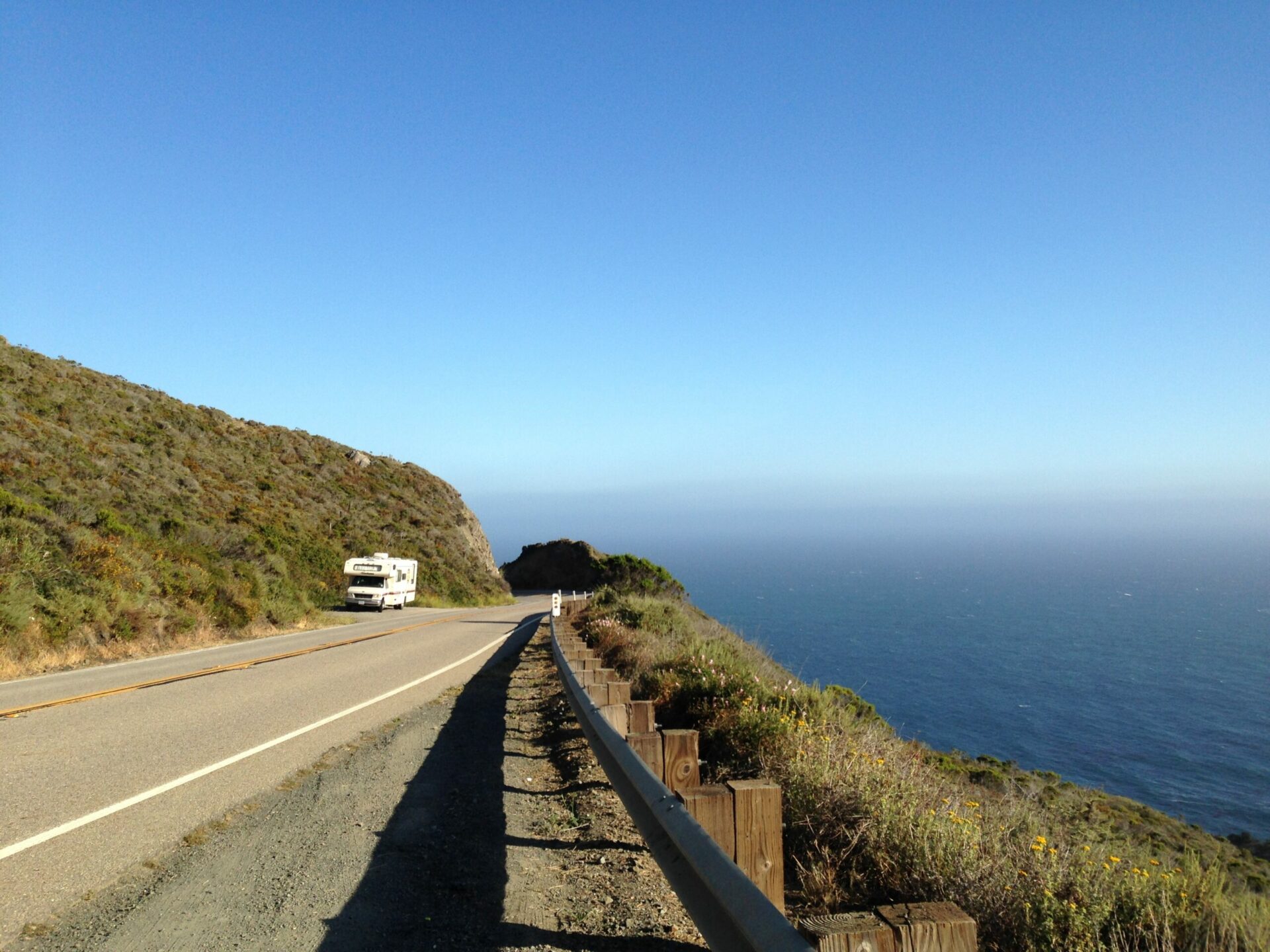 Photo of Franklin, Heath and Alyssa Padgett's first RV, on the side of the road along the Pacific Coast Highway.