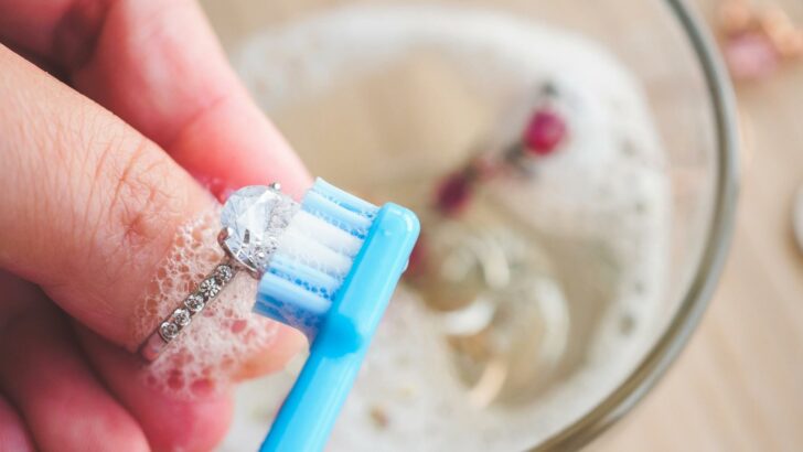 Photo of a person polishing a ring, one of many unconventional uses for toothpaste