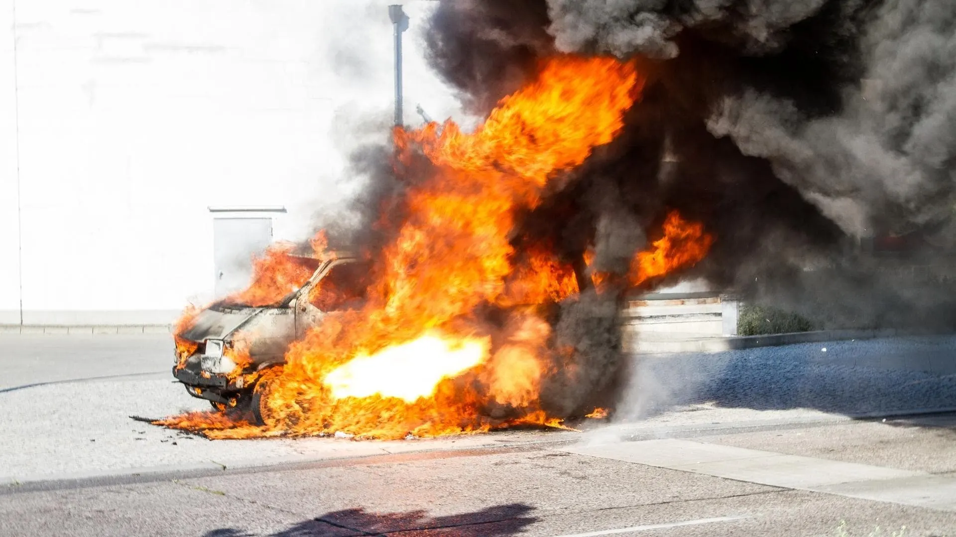 Photo of a small van fully engulfed in flames