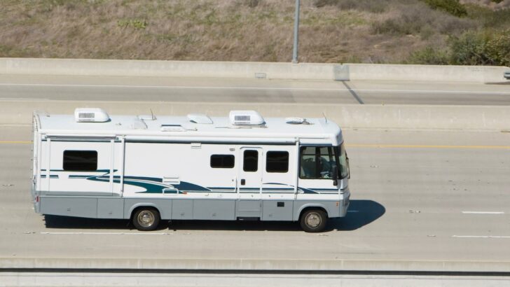 Photo of a Class A RV driving on the right-hand side of a highway