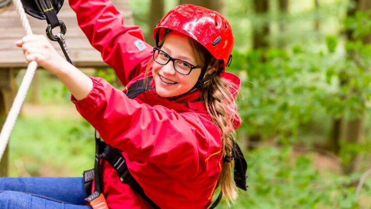 Photo of a teenager on an adventurous ropes course at an RV family vacation destination