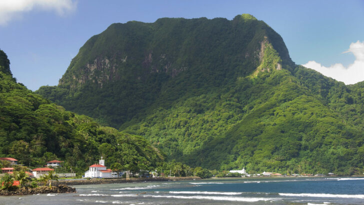 Lush mountain, shore, and turquoise waters of National Park of American Samoa 
