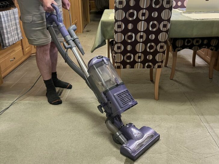 John using our vacuum in the living room of our RV