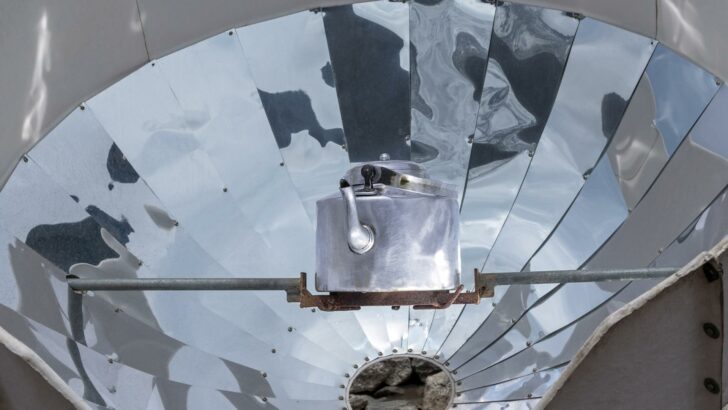 A tea kettle placed inside a parabolic solar cooker