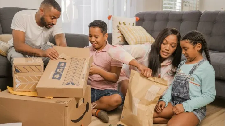 A family surrounded by boxes and packages