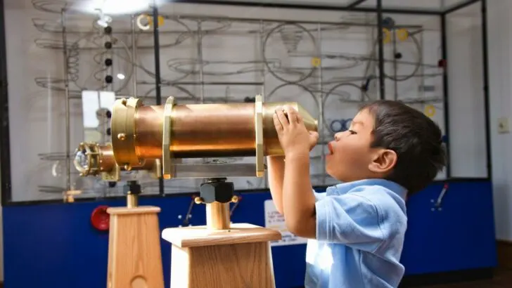 A child discovering something fascinating in a science museum