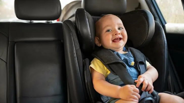 Toddler in a car seat on a road trip