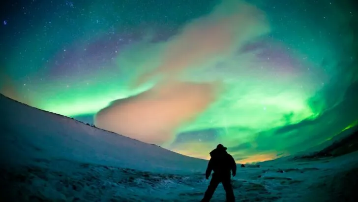 A photo of a person experiencing the Northern Lights in northern Sweden