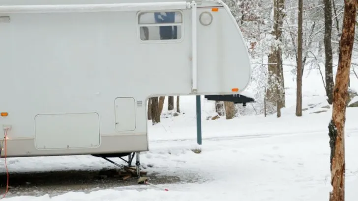 A 5th wheel parked in the snow